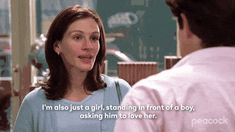 A woman speaks emotionally to a man indoors, saying, “I’m also just a girl, standing in front of a boy, asking him to love her,” capturing the heartfelt essence often sought in copywriting for creatives.